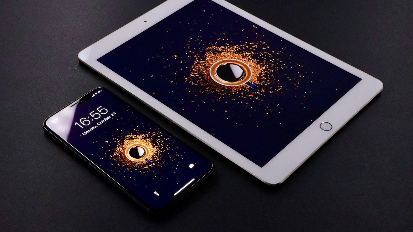 gold Apple iPad and black smartphone