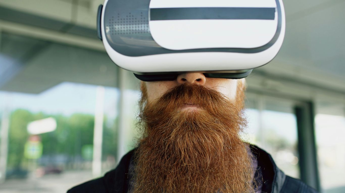 Man with long beard wearing virtual reality headset