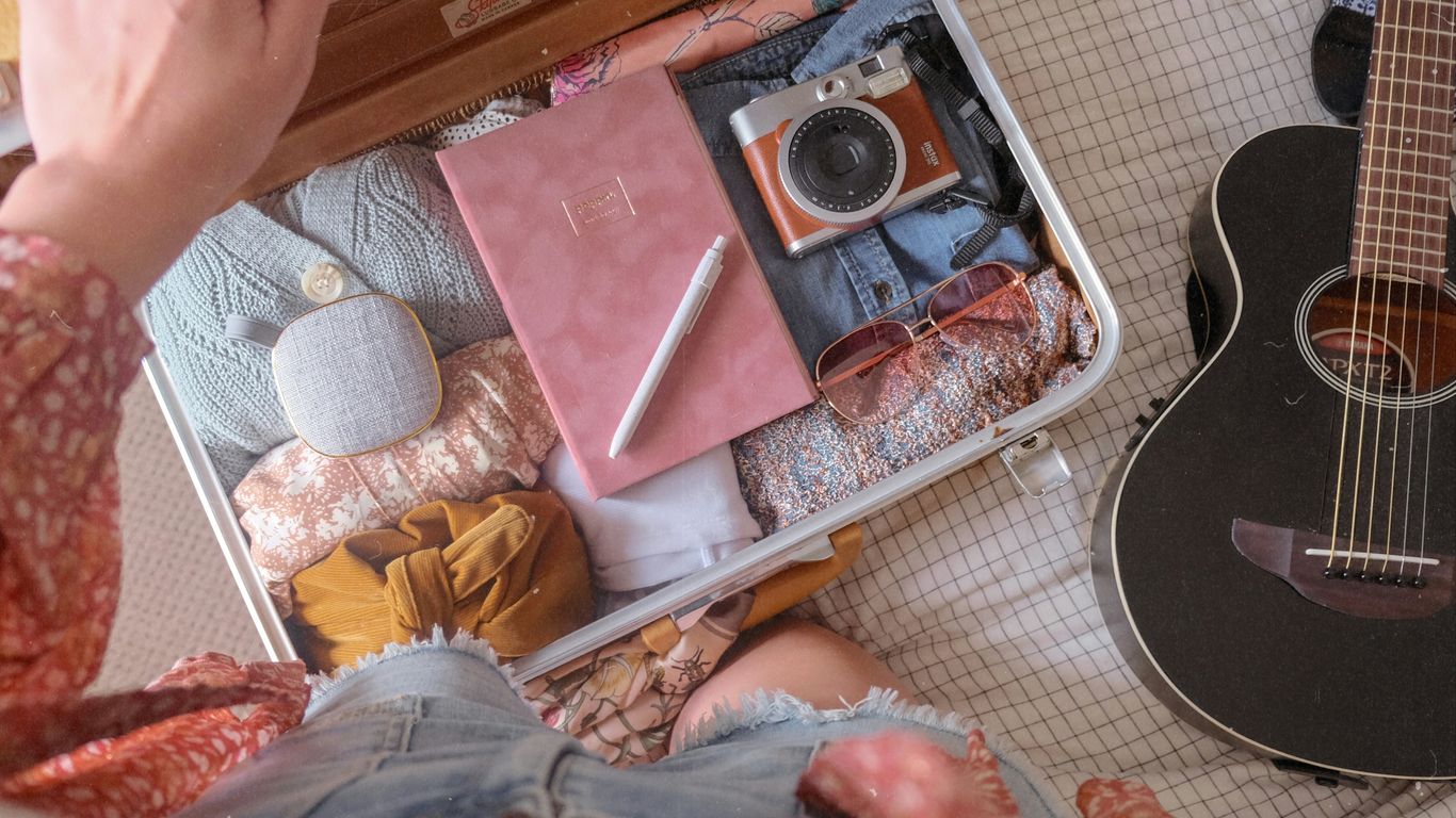 a person sitting on the floor next to a guitar