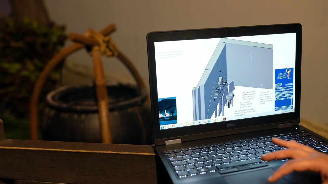 black and silver laptop computer on brown wooden table