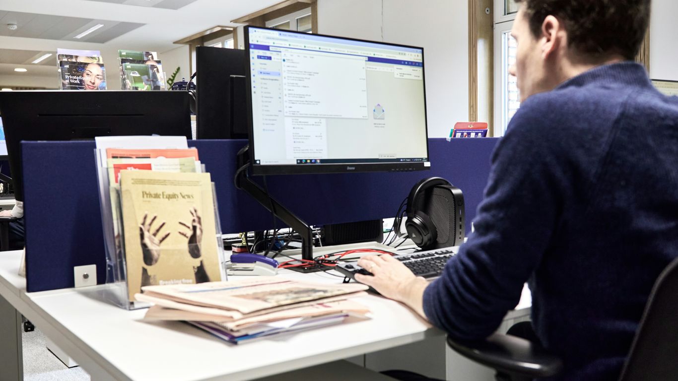 Man working at a computer in an office.