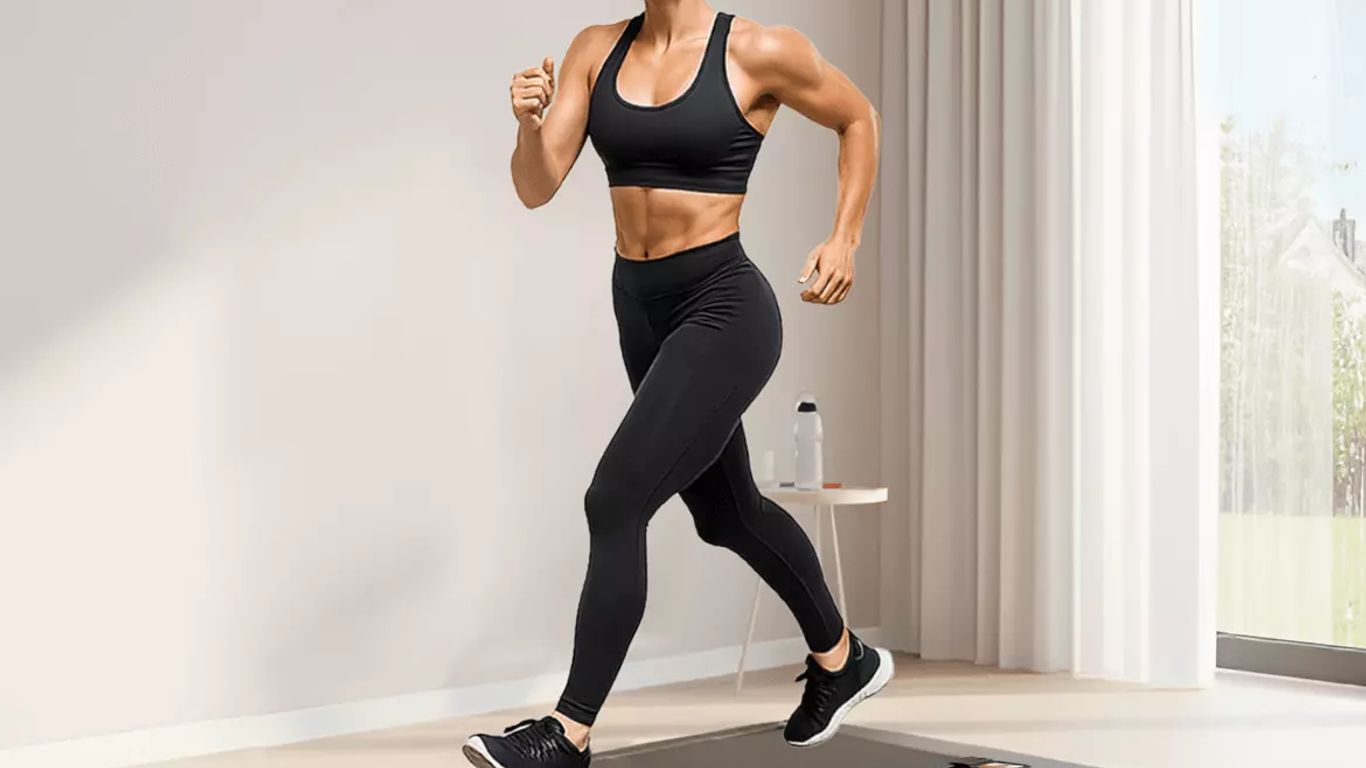 A person runs on a treadmill in a bright, modern room.