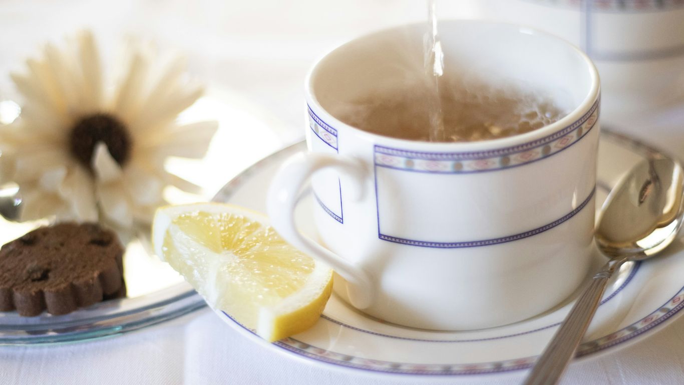 white ceramic mug with yellow liquid inside