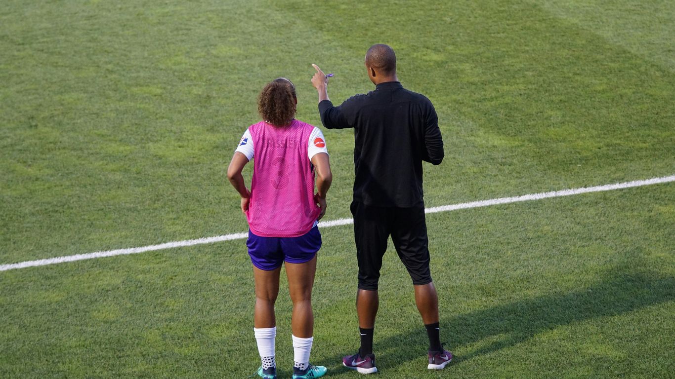 man and woman standing on field