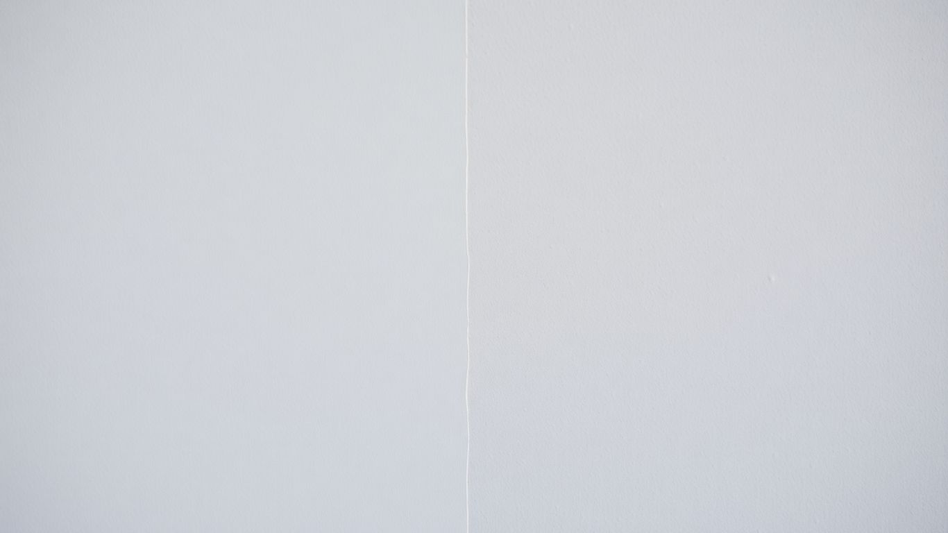 Wall with flawless paint finish next to unprimed surface.