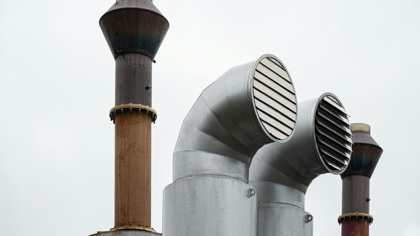 a group of metal pipes with a sky in the background