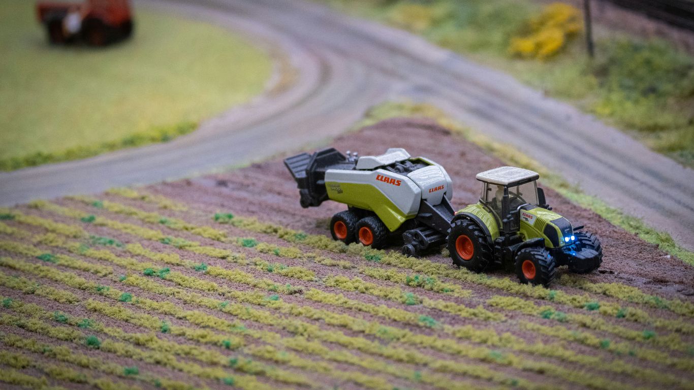 a tractor and a tractor trailer in a field