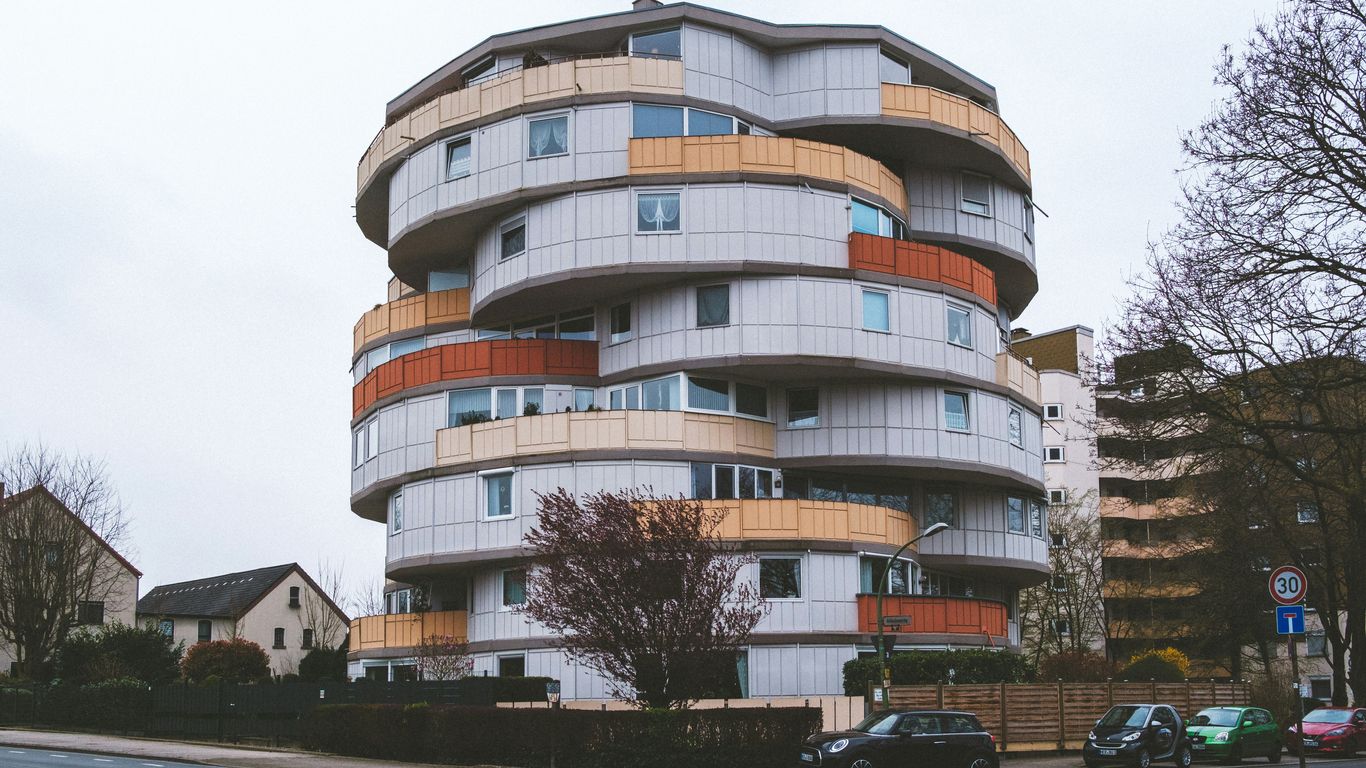 a very tall building sitting on the side of a road