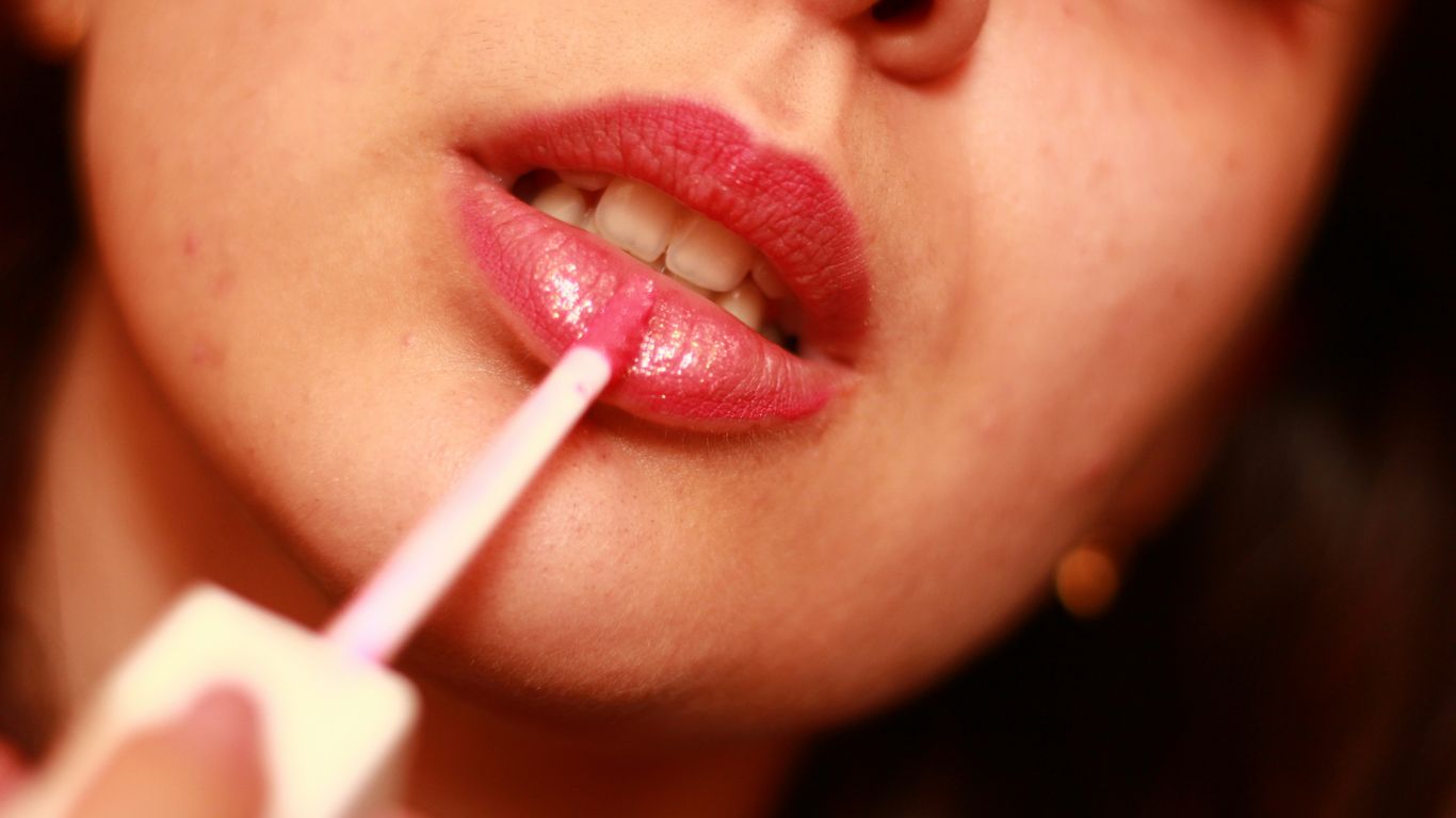 A close up of a woman brushing her teeth