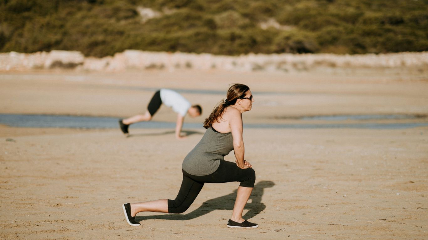 woman wearing grey tank top doing exercise