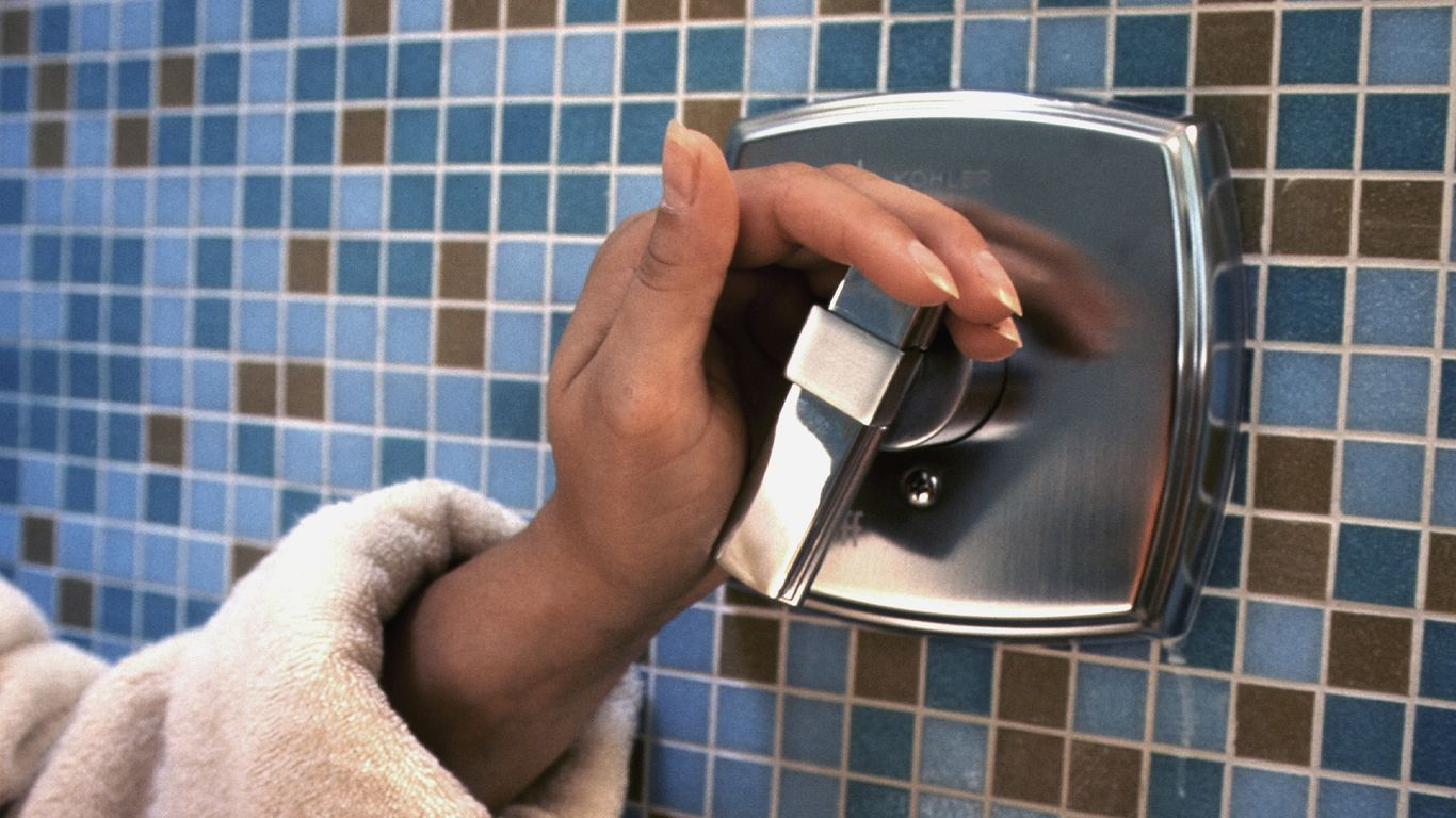 a person's hand on a soap dispenser