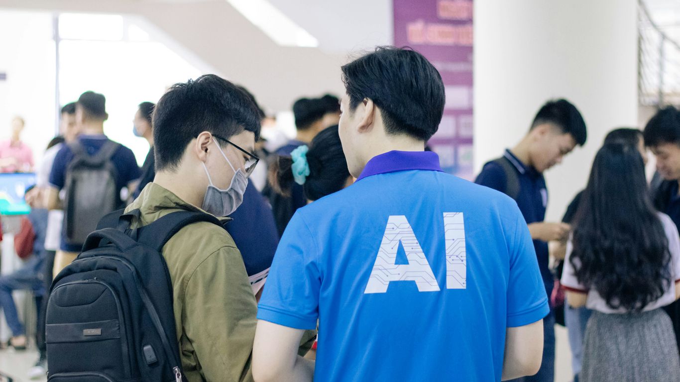 man in blue crew neck t-shirt standing near people