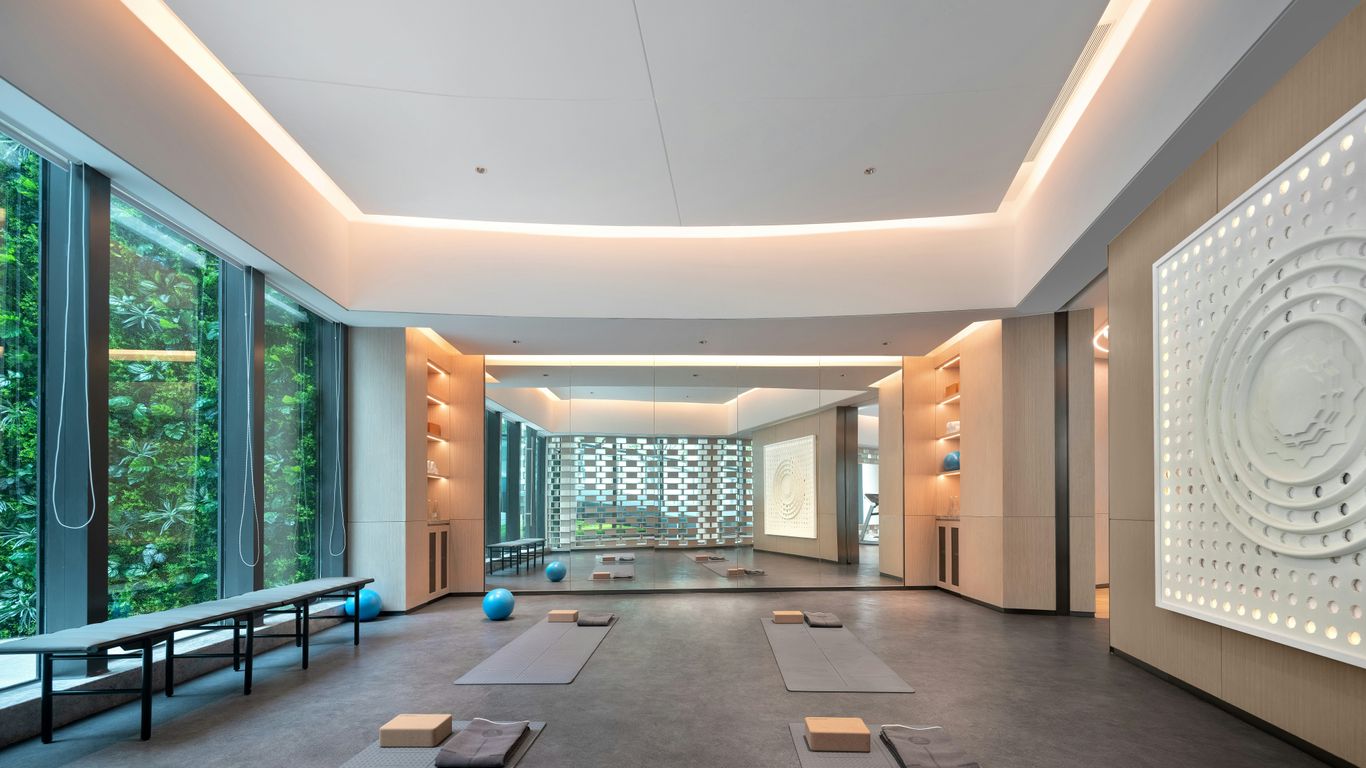 Modern yoga studio with large windows and mats.