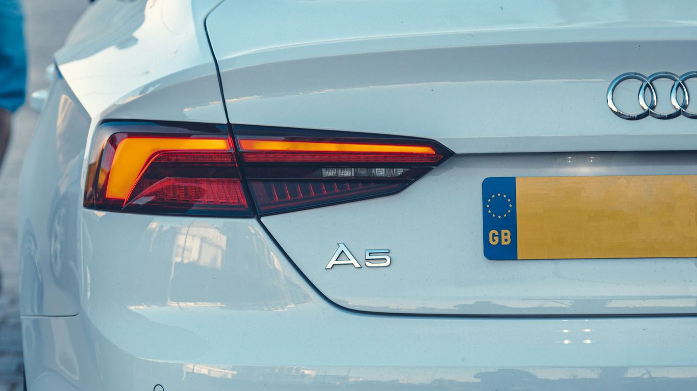 a close up of the tail lights of a white car
