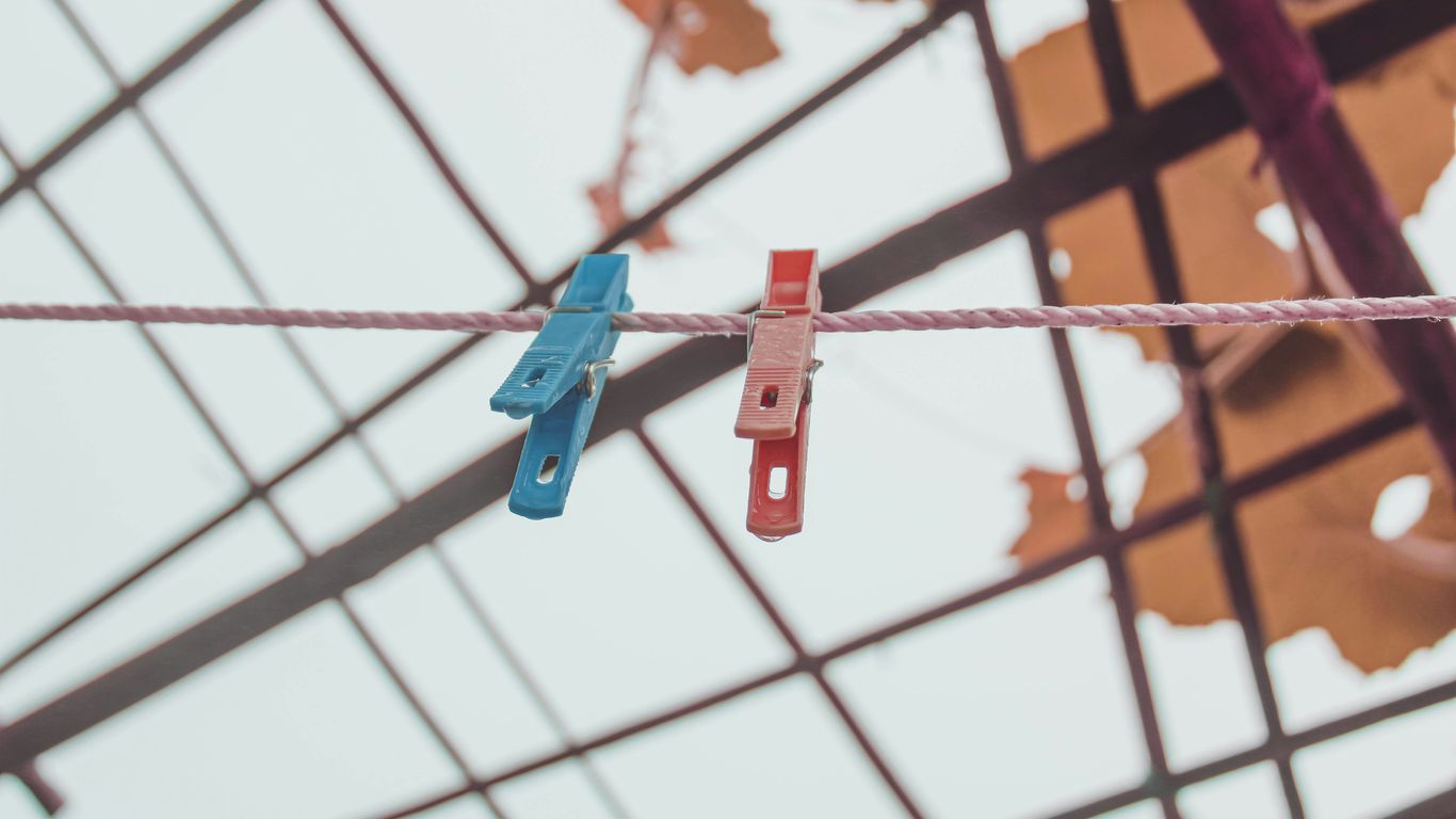 a couple of clothes pins hanging from a rope