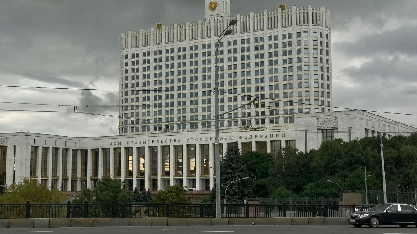 white concrete building near green trees during daytime