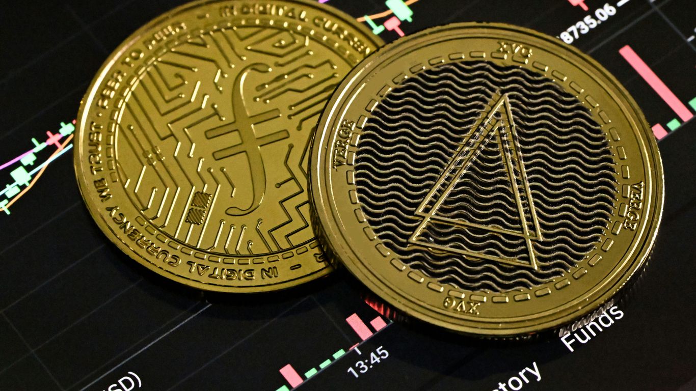 Two gold cryptocurrency coins on a stock market chart background.