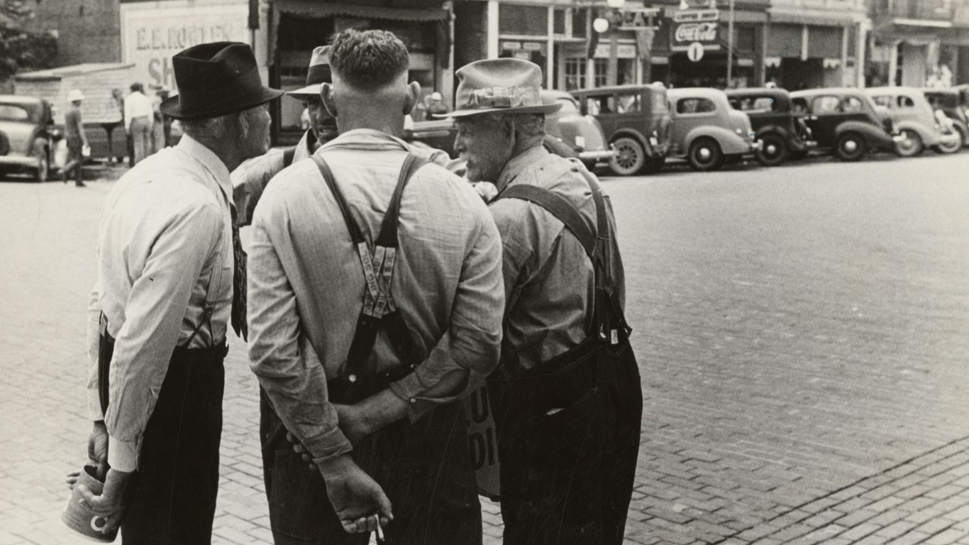 a group of men standing next to each other on a street