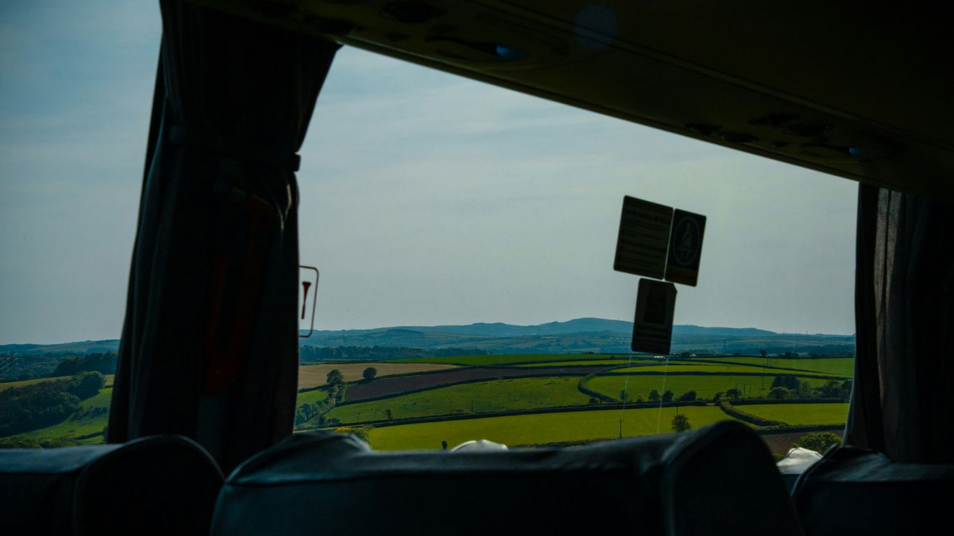 a view of a field from inside a vehicle