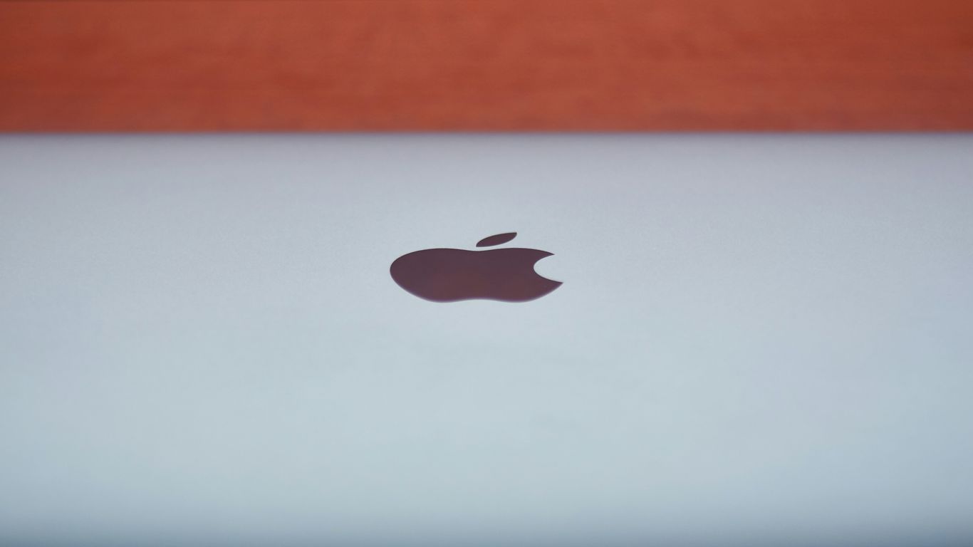 silver macbook on brown wooden table