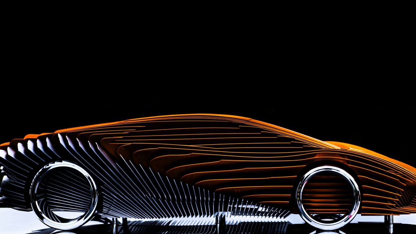 Abstract sculpture of a car with orange and silver details.