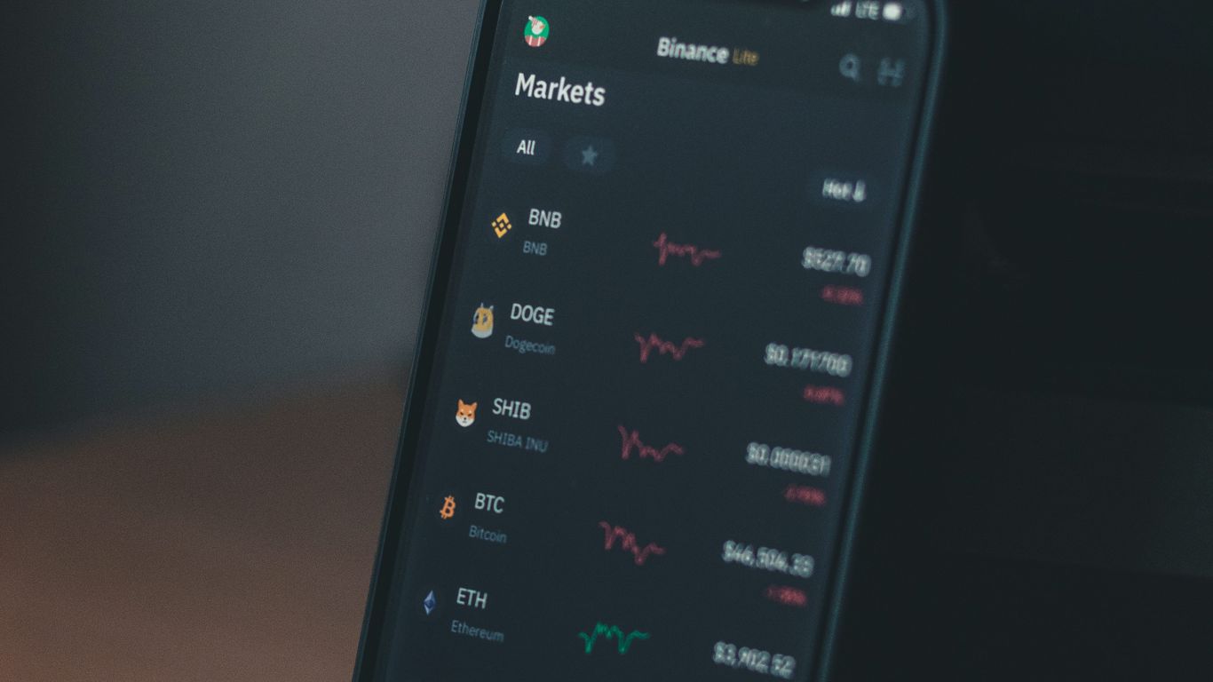A smartphone displaying cryptocurrency market prices and trends.
