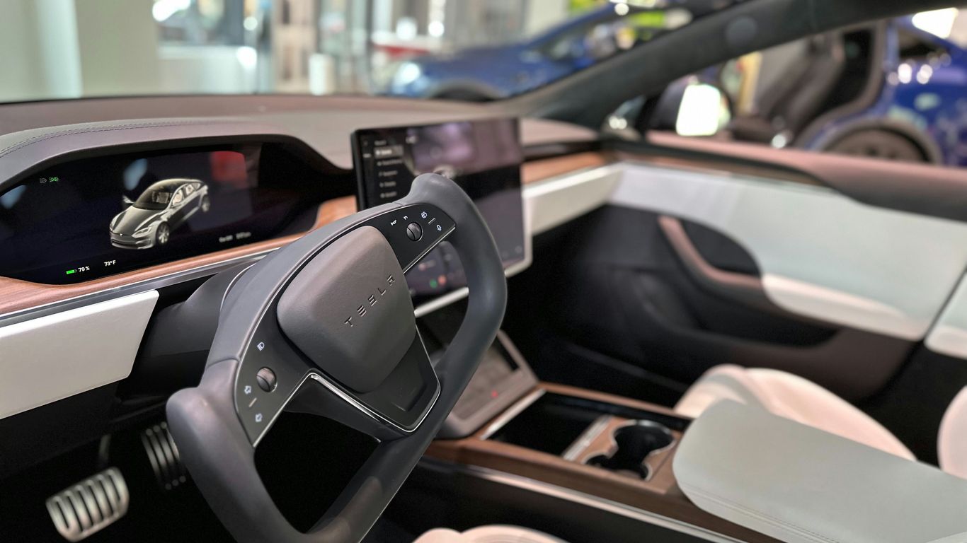 The inside of a car with a steering wheel and dashboard