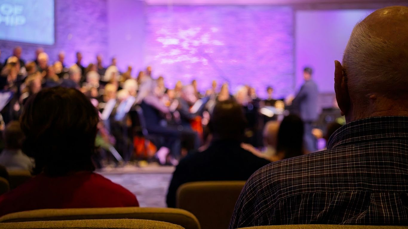 Audience watches a choir perform on stage.