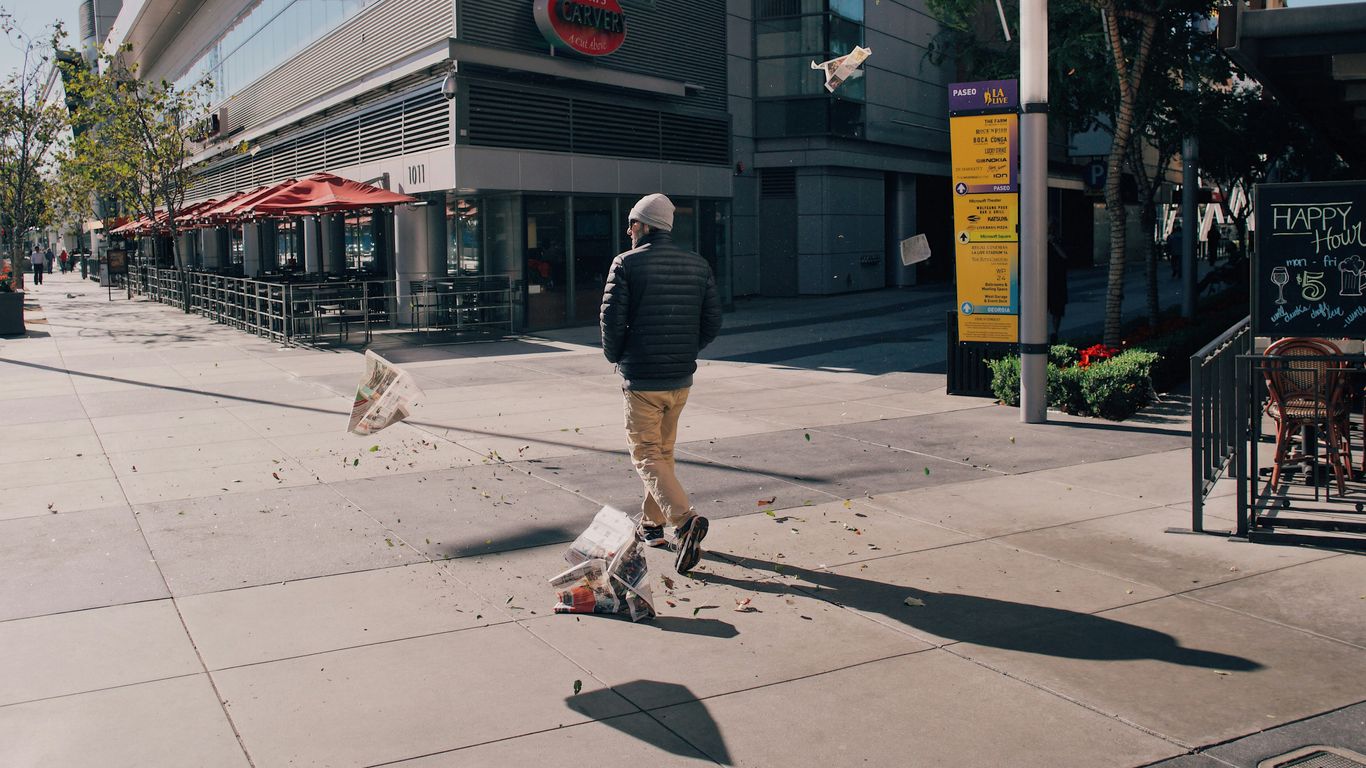 person in brown pants near concrete building