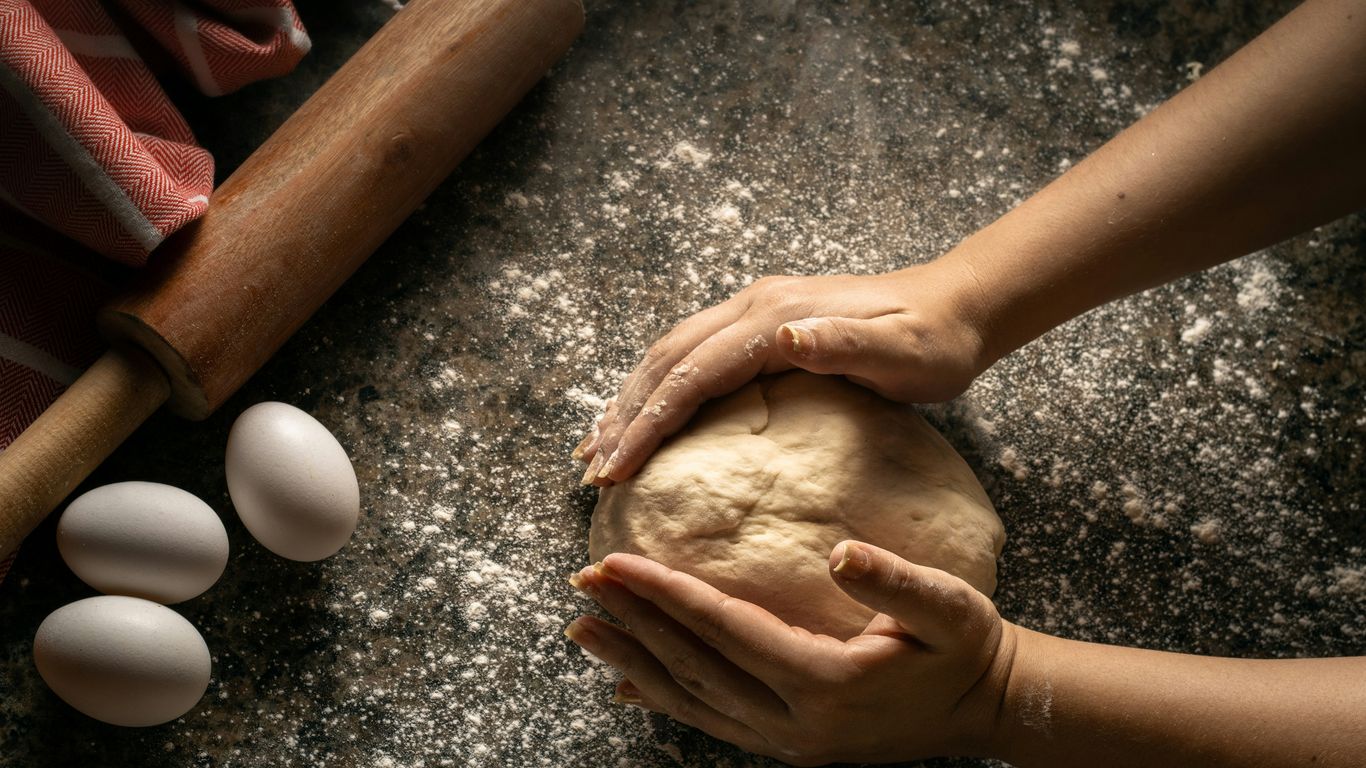 hands holding a pile of dirt