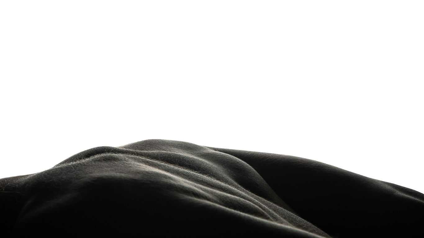 a person laying down with their head on a pillow