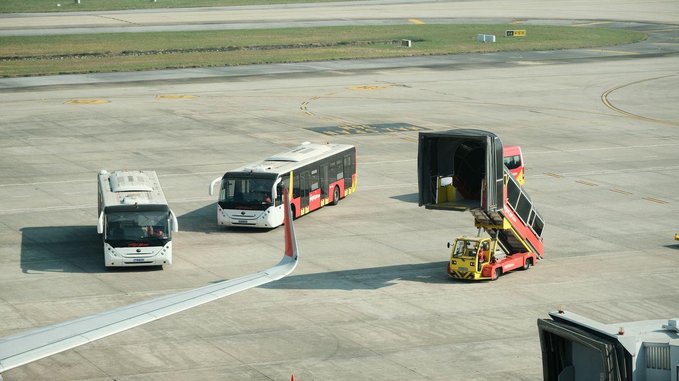 A group of buses sitting on top of an airport tarmac