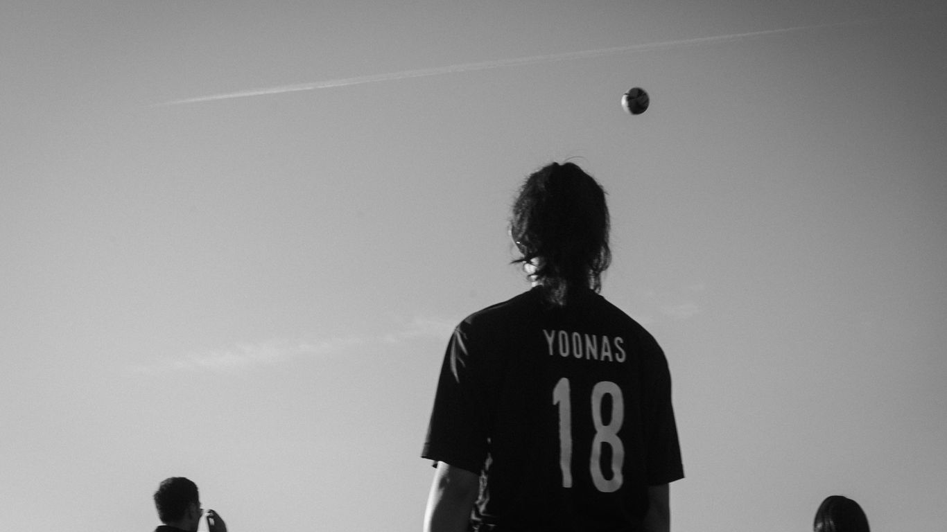 A group of young men playing a game of soccer
