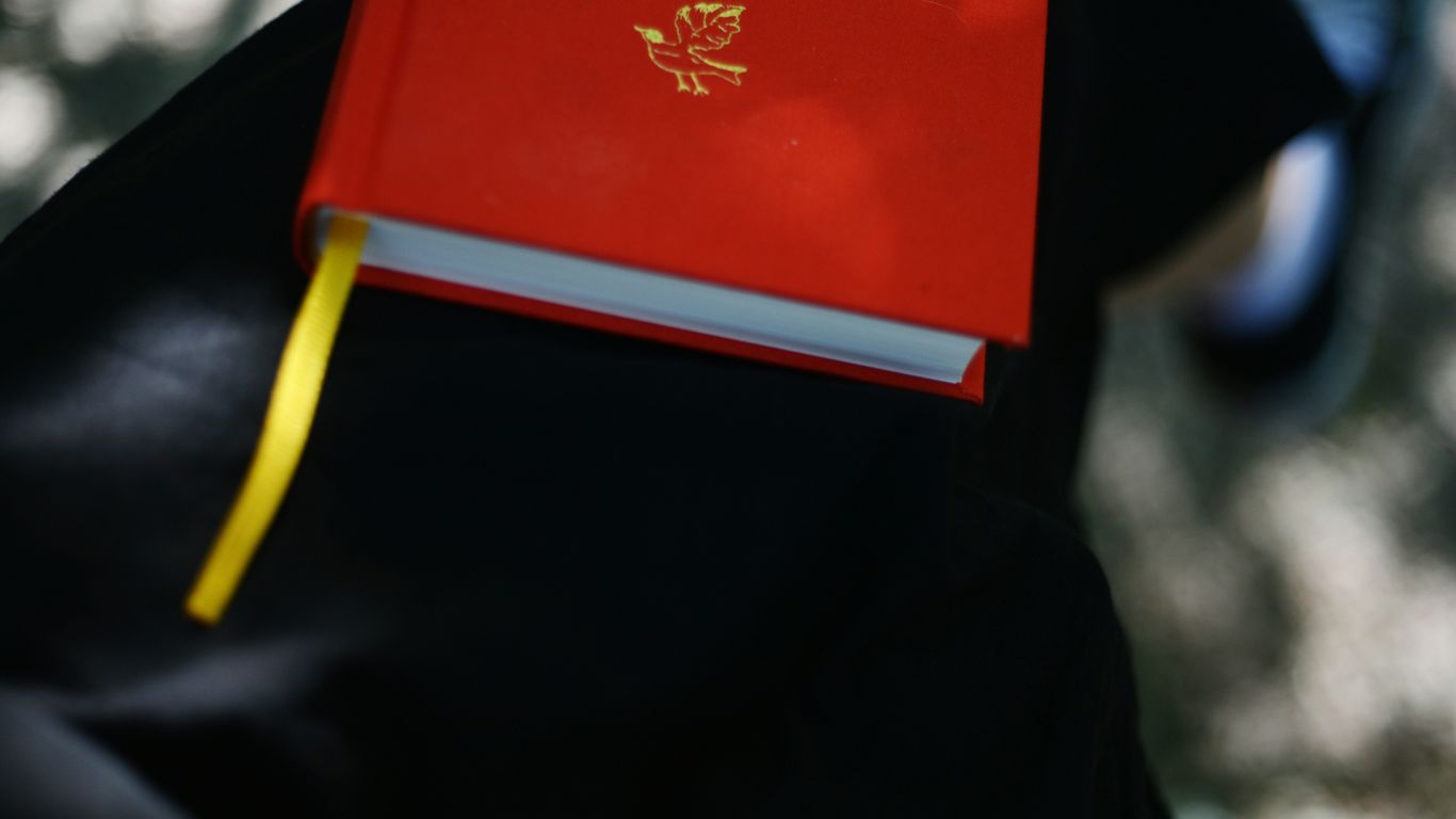 A red book with a yellow bookmark.