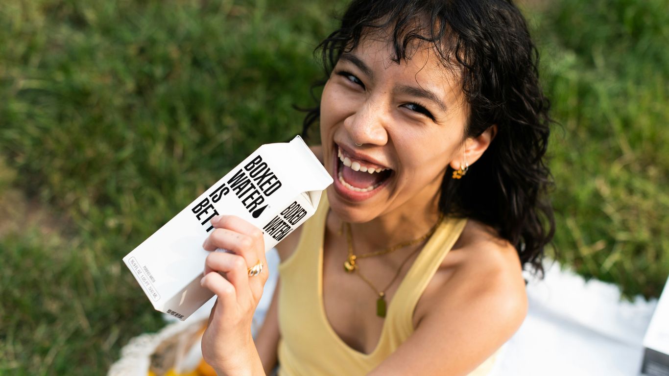 a woman holding up a piece of white paper