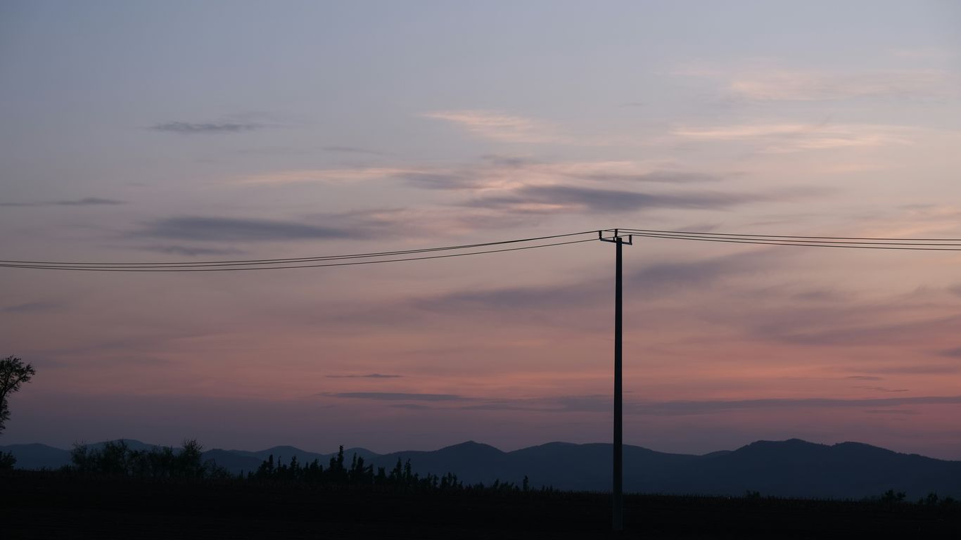 a telephone pole in the middle of a field