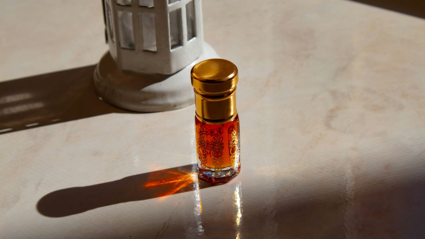 A small bottle of perfume sitting on a table