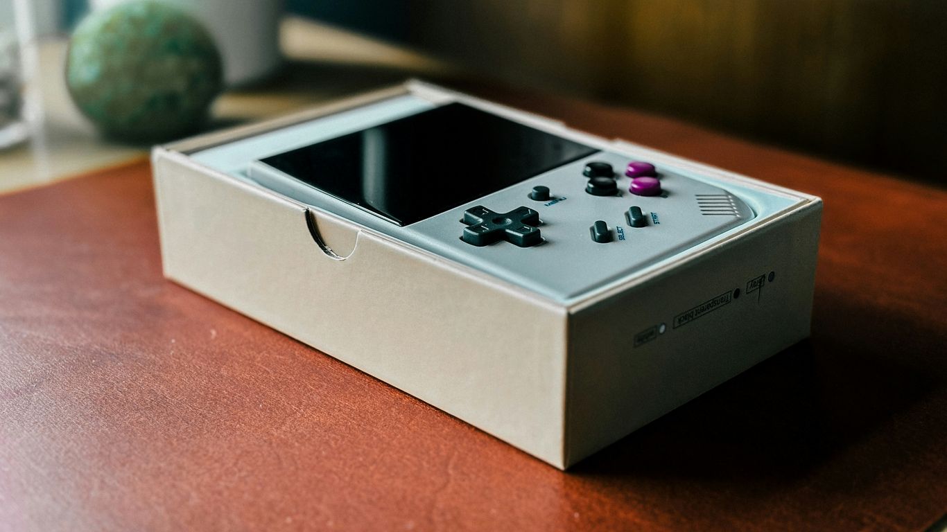 A nintendo wii controller sitting on top of a wooden table