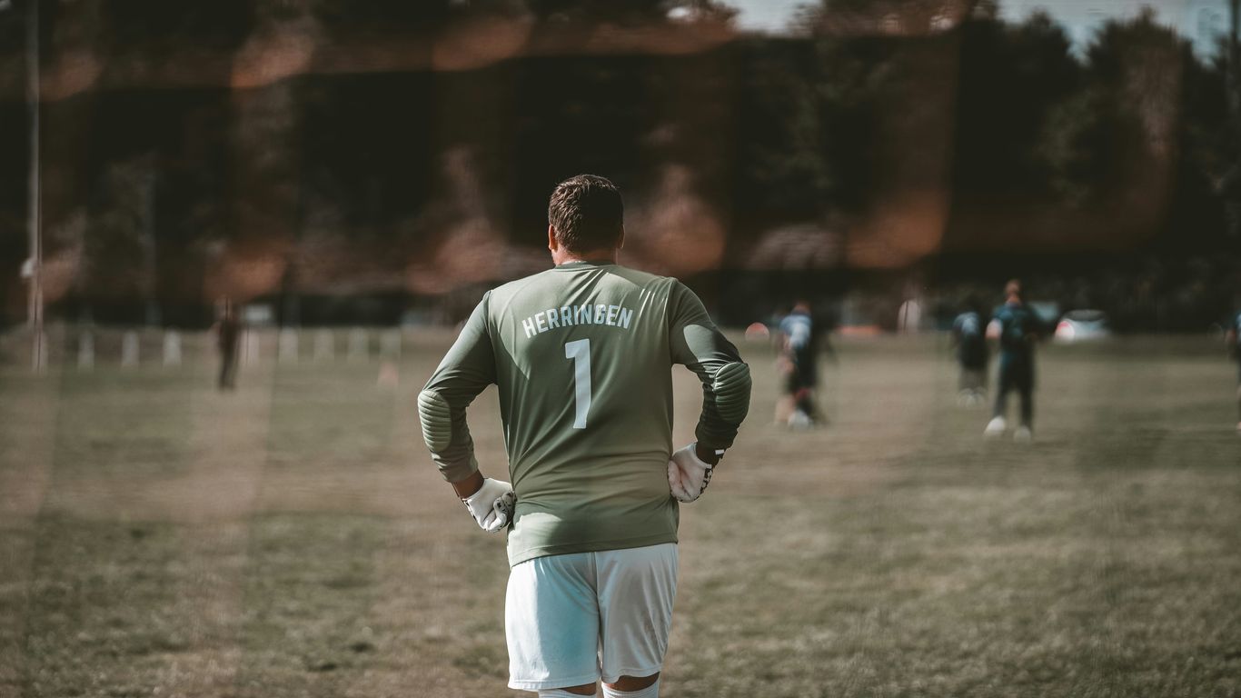 man in green and white nike long sleeve shirt and white pants