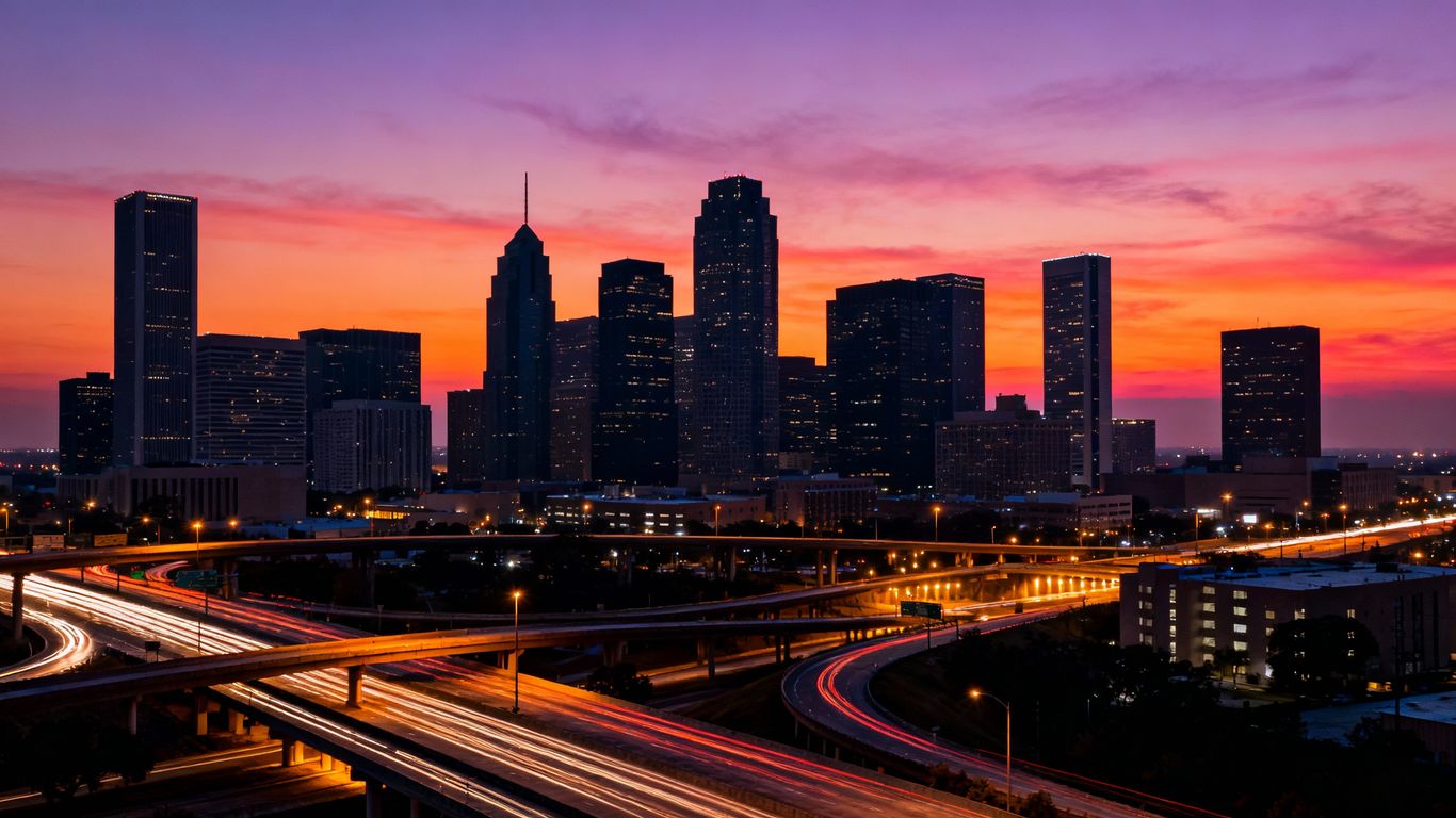 Houston skyline at dusk with city lights.