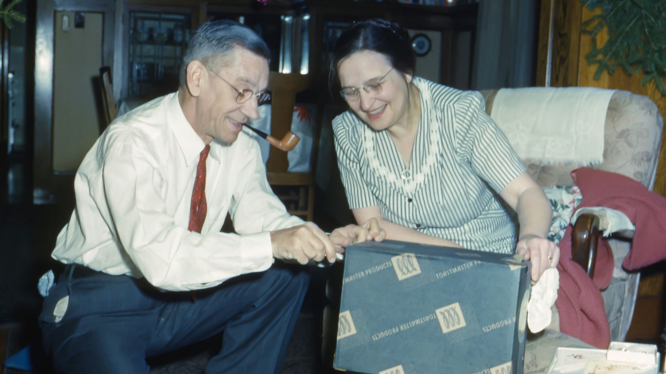 man and woman holding black box