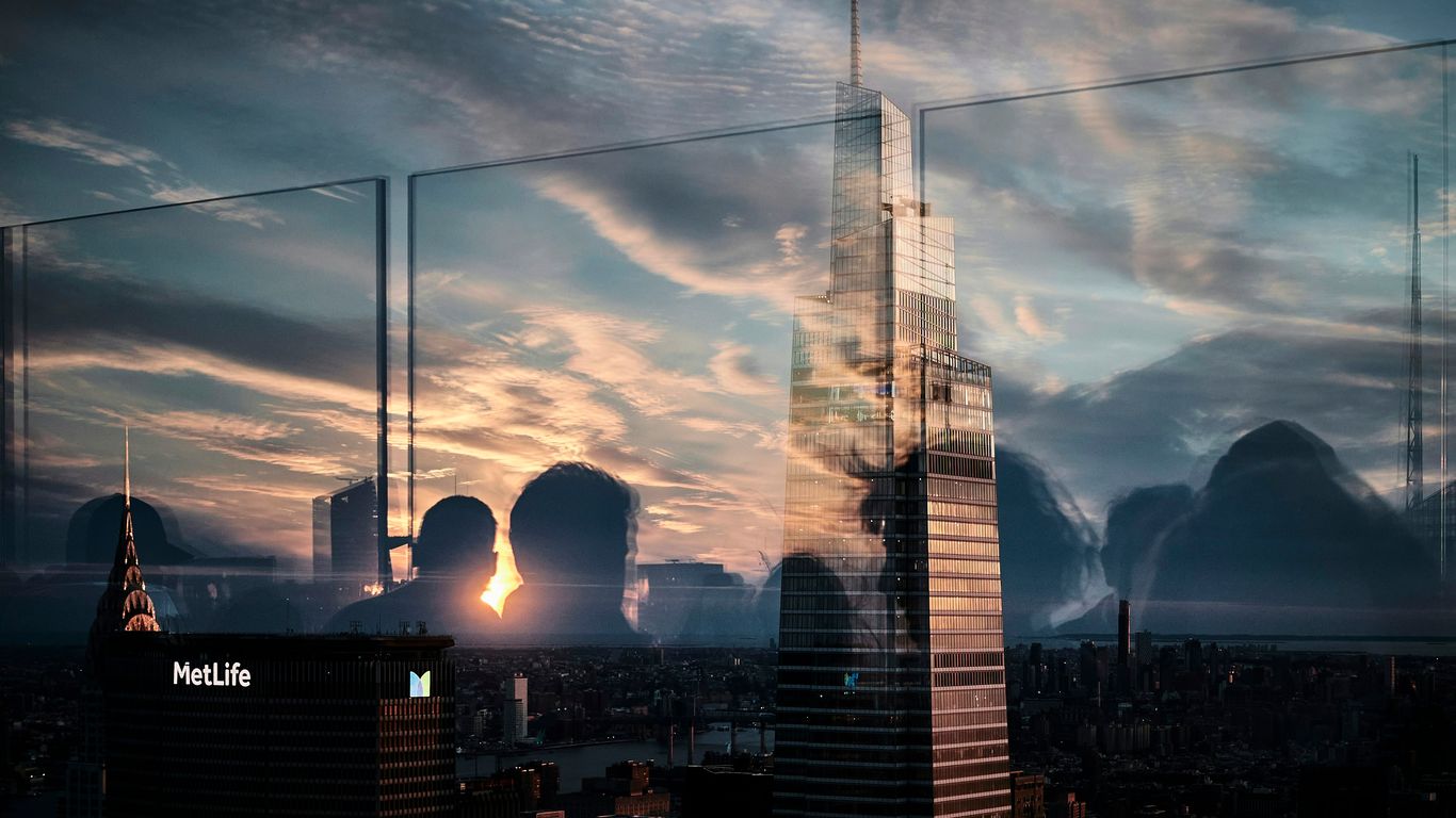 a tall building with a bridge in the background