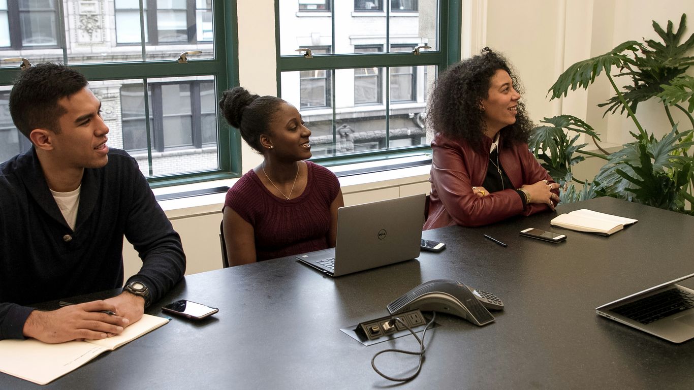 a group of people sitting around a table