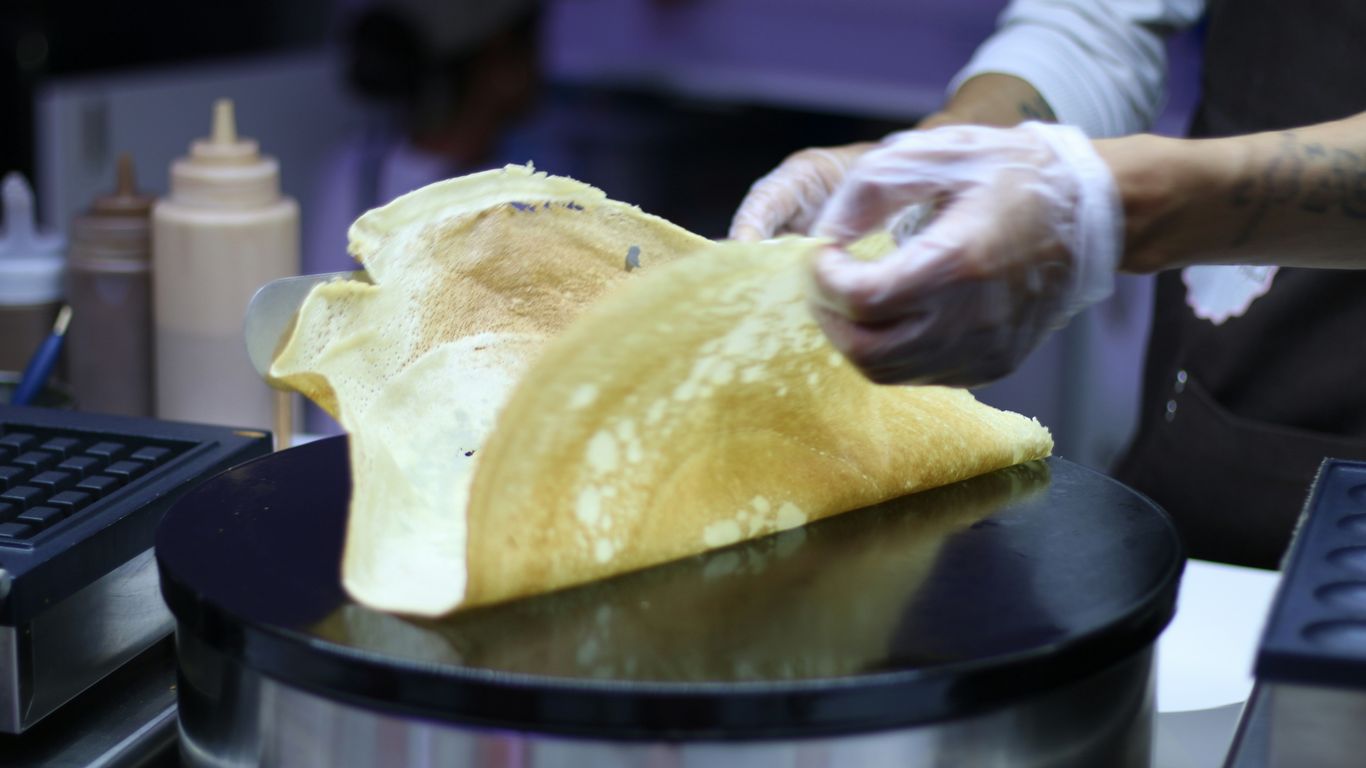 a person in a kitchen preparing food on a stove