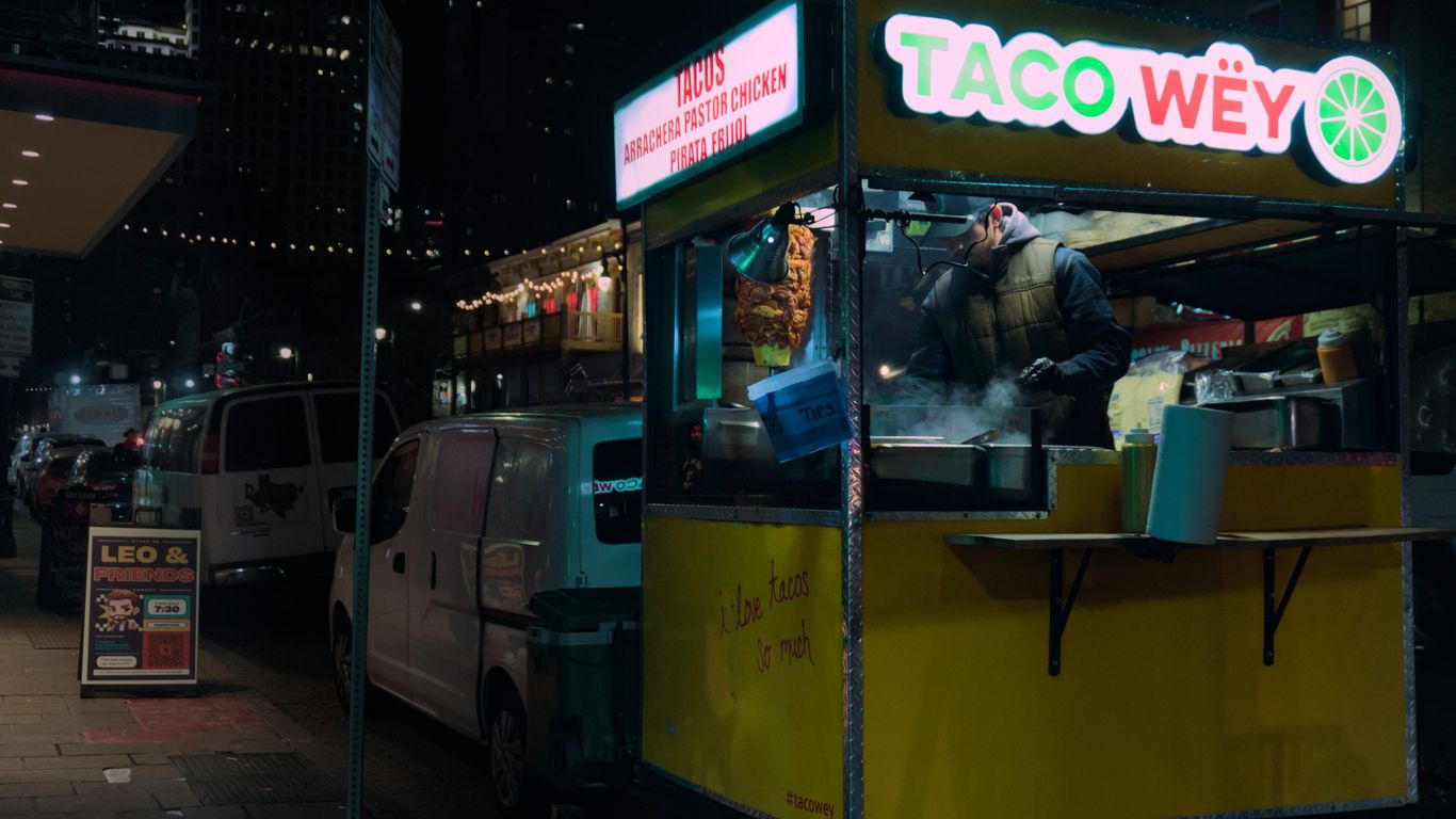 a taco truck parked on the side of a street