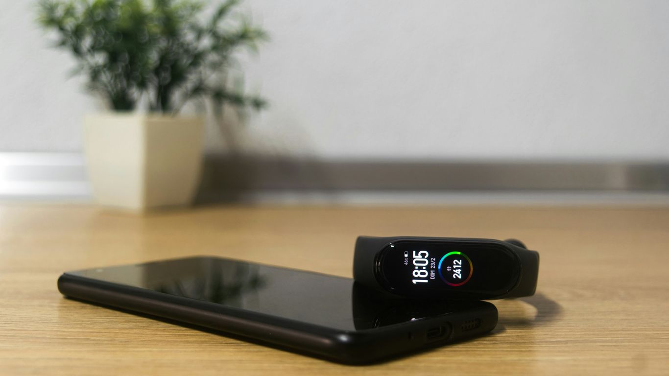 black smartphone on brown wooden table
