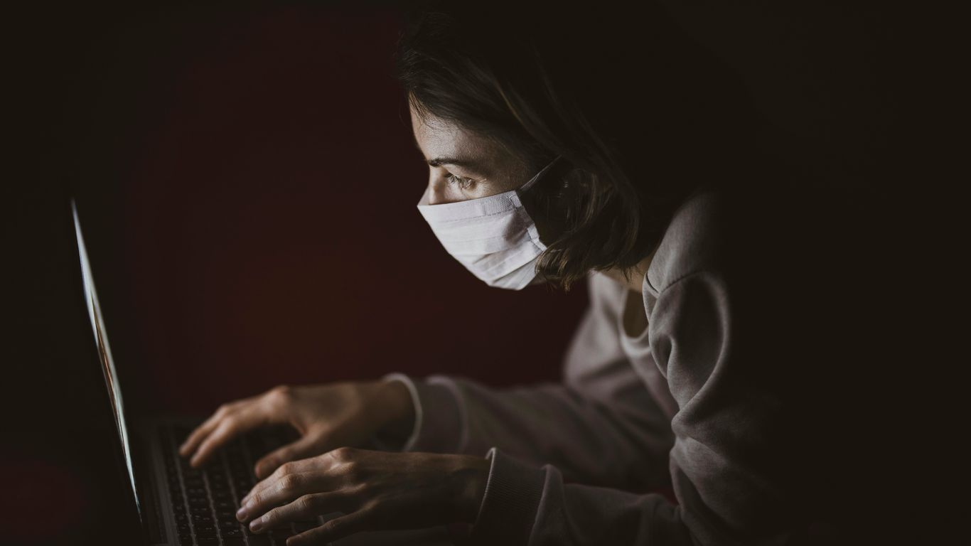 woman in black long sleeve shirt using laptop computer