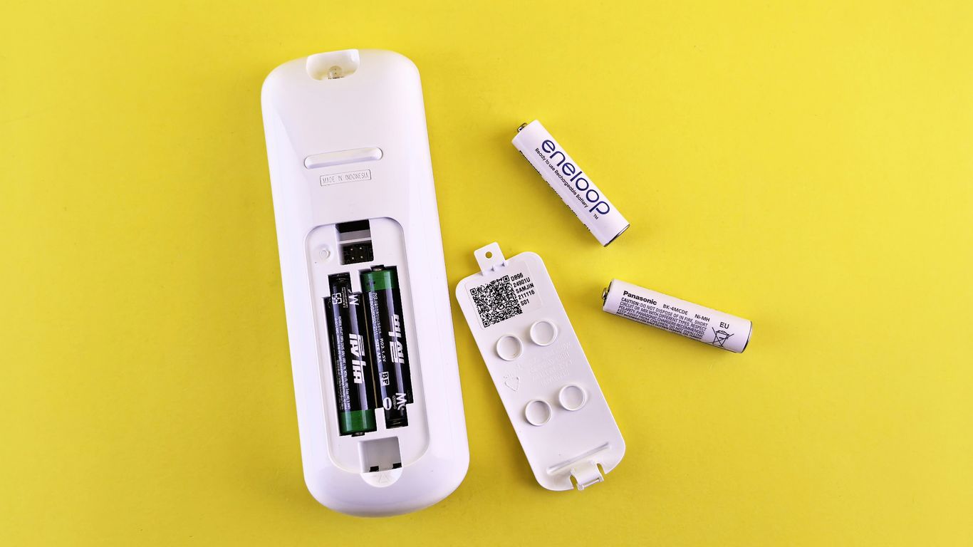 A couple of remote controls sitting on top of a table