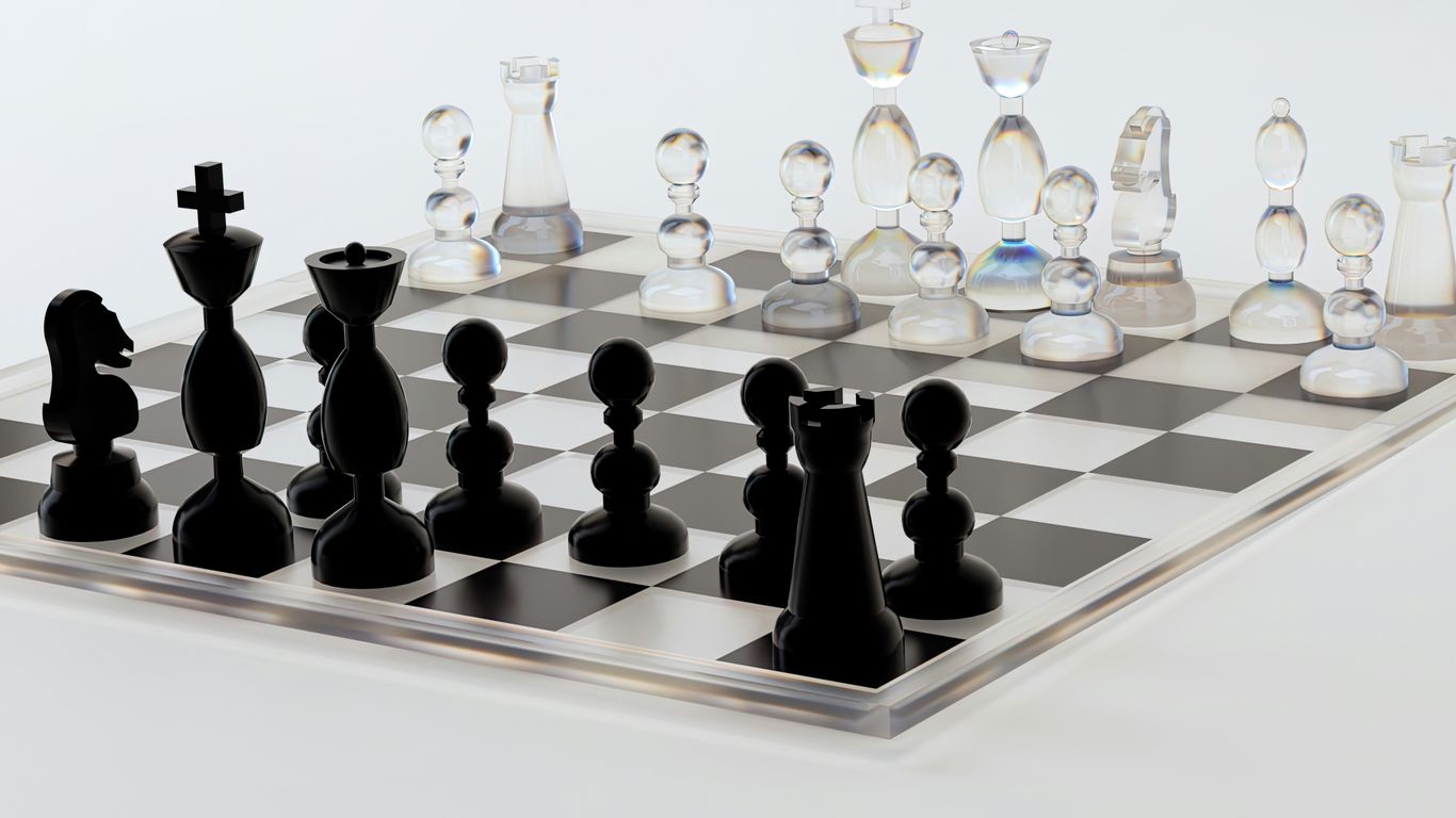 a glass chess board with black pieces on it