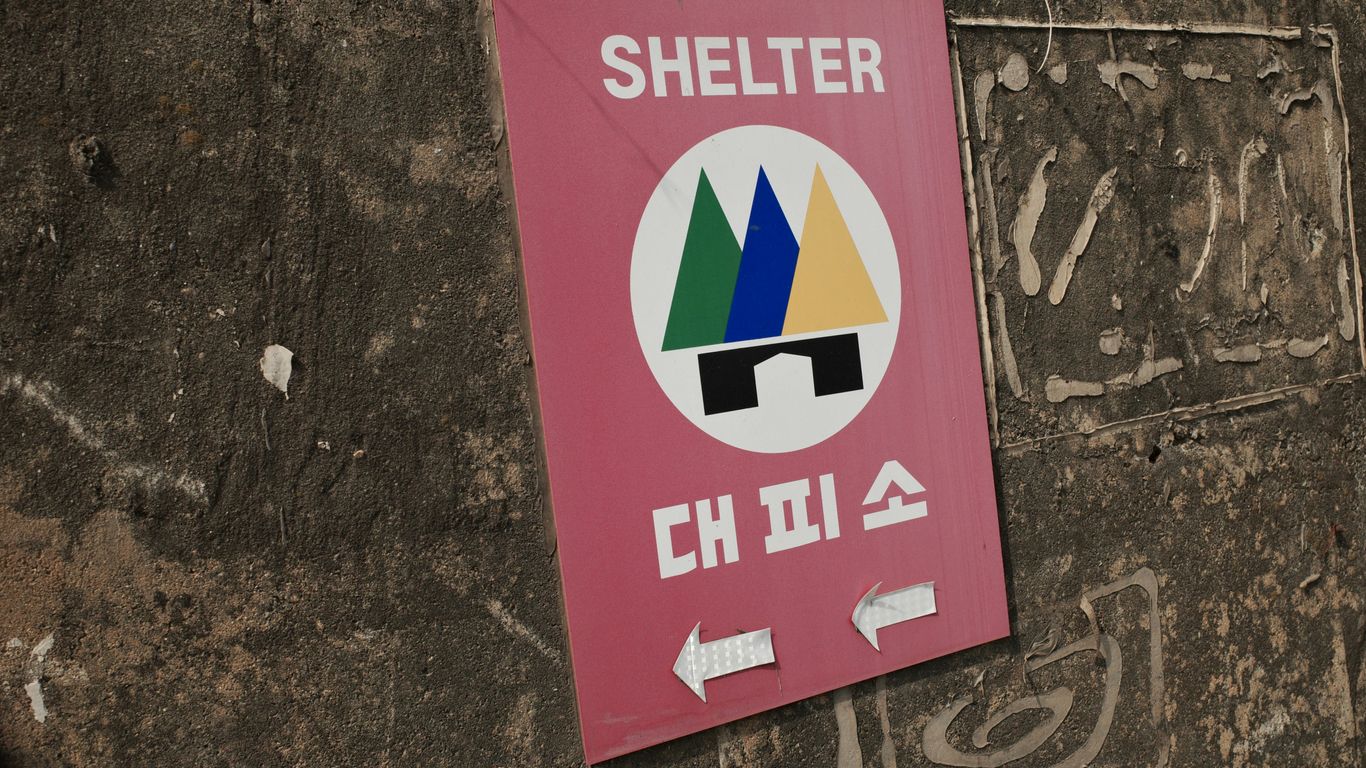 a sign on the side of a building that says shelter